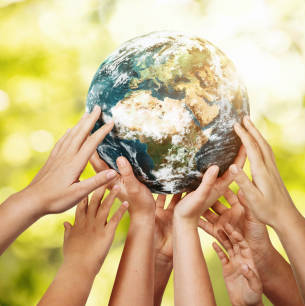 Group of children holding planet earth over defocused nature background with copy space. Element of this image furnished by NASA ( https://earthobservatory.nasa.gov/blogs/elegantfigures/2011/10/06/crafting-the-blue-marble/ )